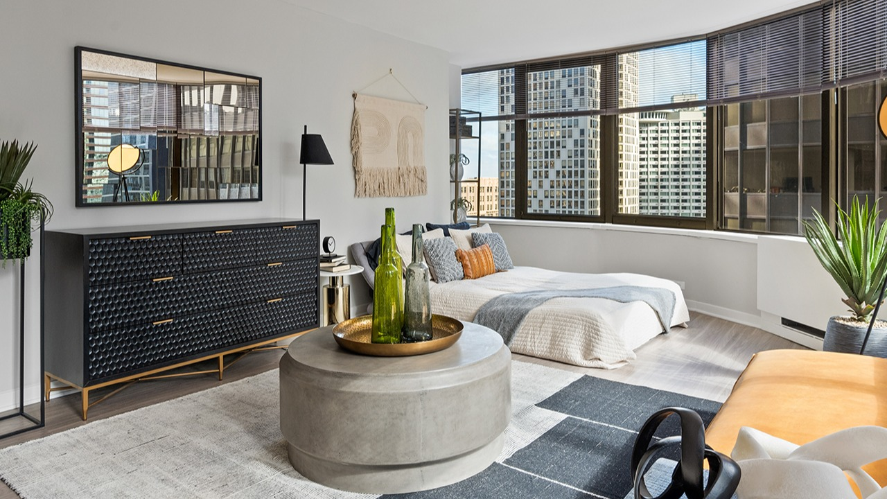 Stylish studio apartment at Arrive Streeterville featuring a combined living and sleeping area with city views
