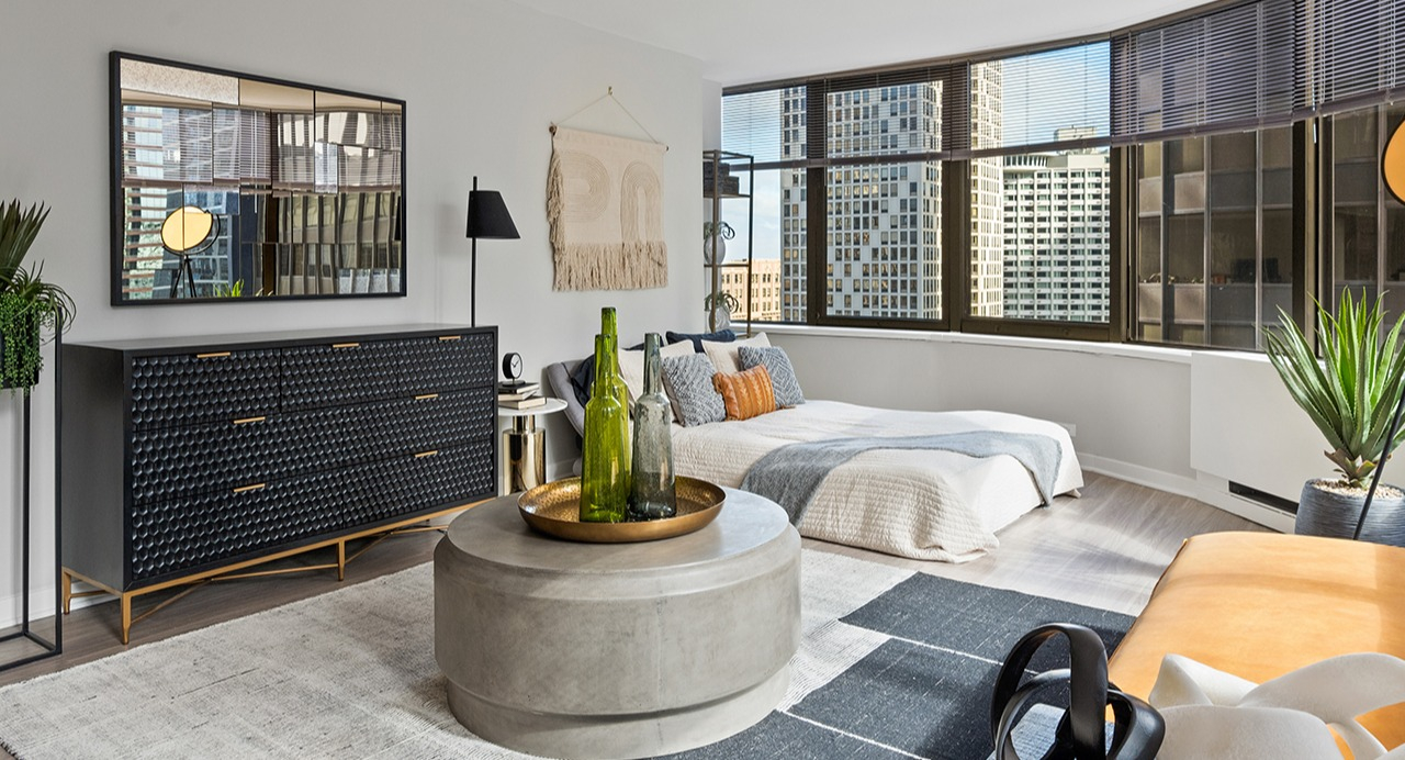 Stylish studio apartment at Arrive Streeterville featuring a combined living and sleeping area with city views