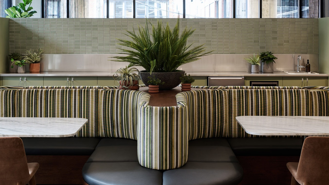 Charming cafe-style seating area at Arthur on Aberdeen in Chicago, featuring comfortable banquettes and individual tables
