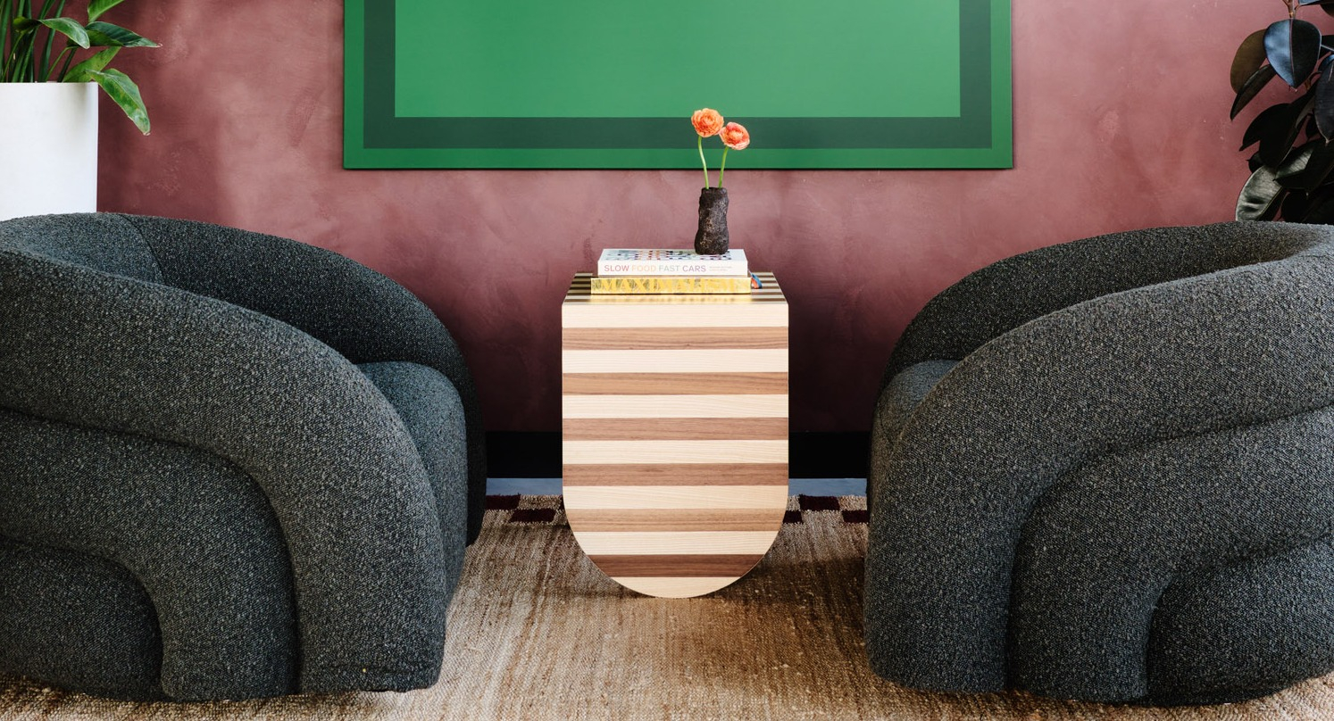 Inviting and cozy sitting area at Arthur on Aberdeen in Chicago with unique upholstered chairs and striking green artwork