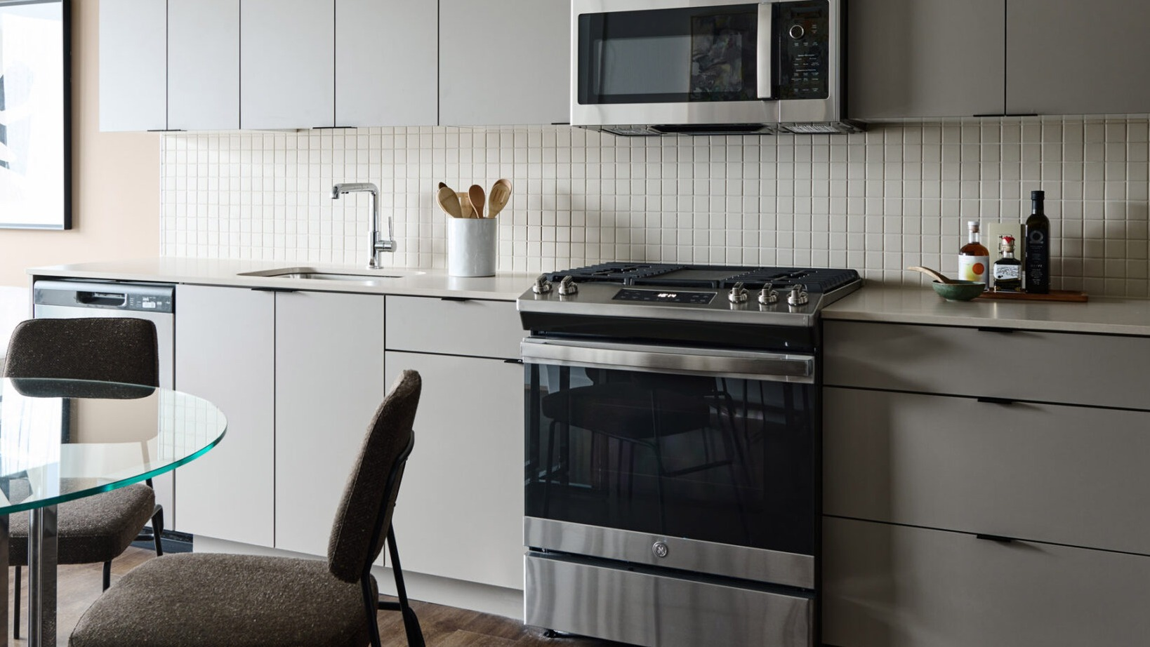Modern kitchen and dining area in an apartment at Arthur on Aberdeen in Chicago, featuring sleek cabinetry and appliances