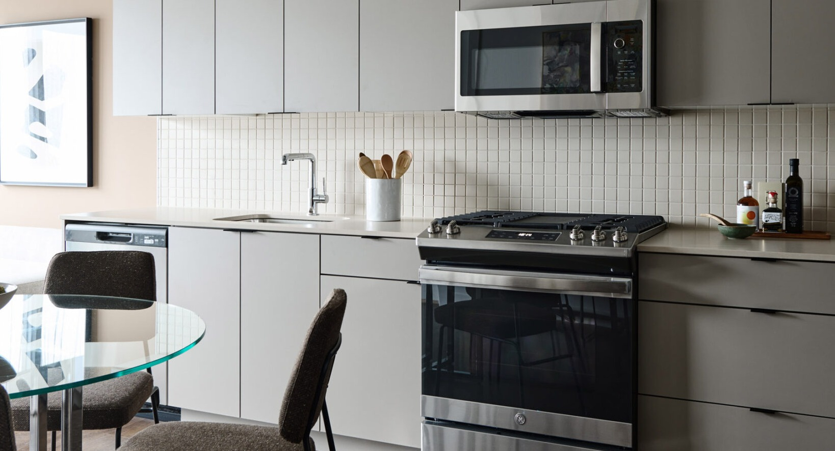Modern kitchen and dining area in an apartment at Arthur on Aberdeen in Chicago, featuring sleek cabinetry and appliances