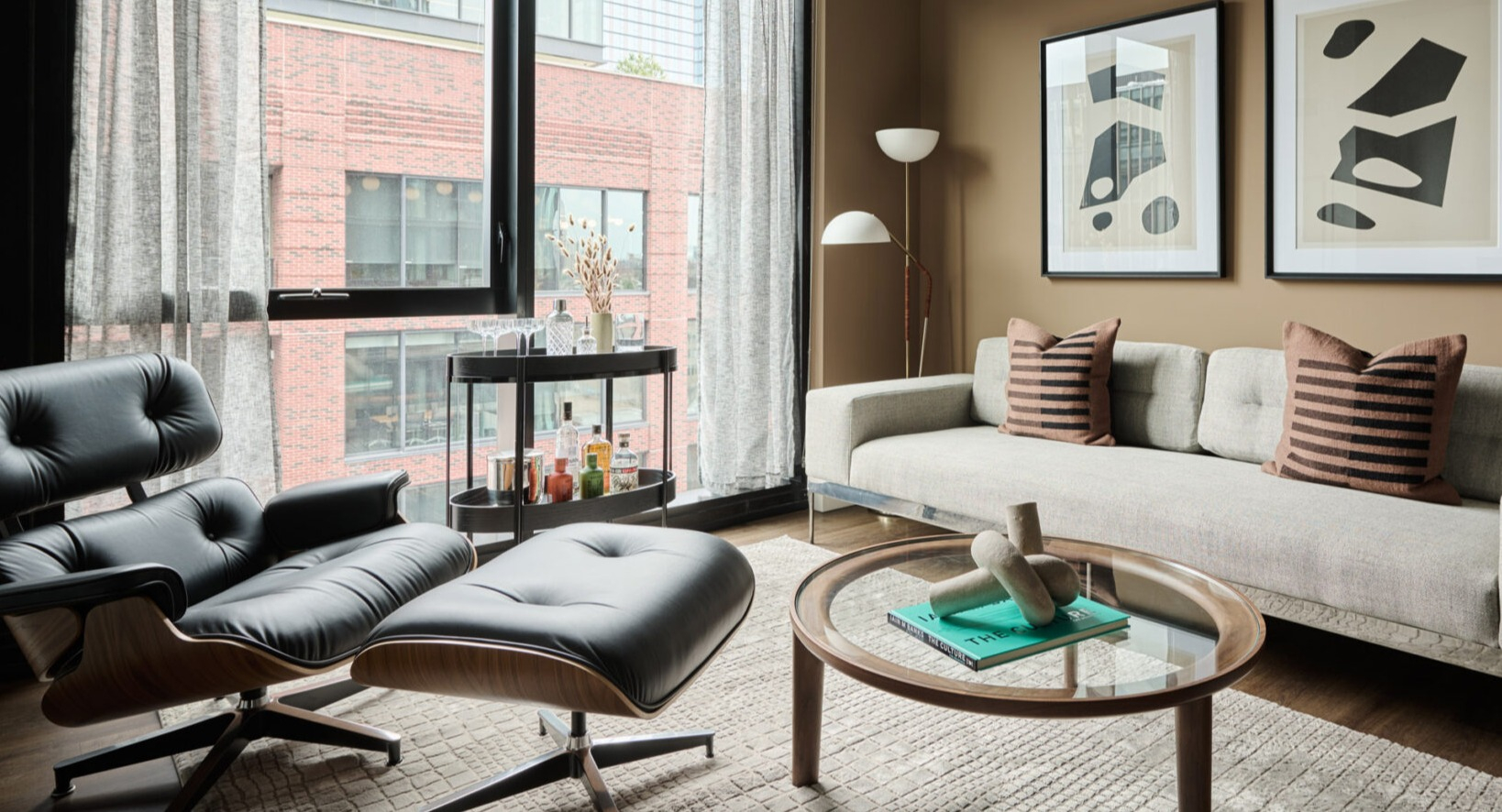 Stylish living room in an Arthur on Aberdeen apartment in Chicago, with comfortable seating and large windows