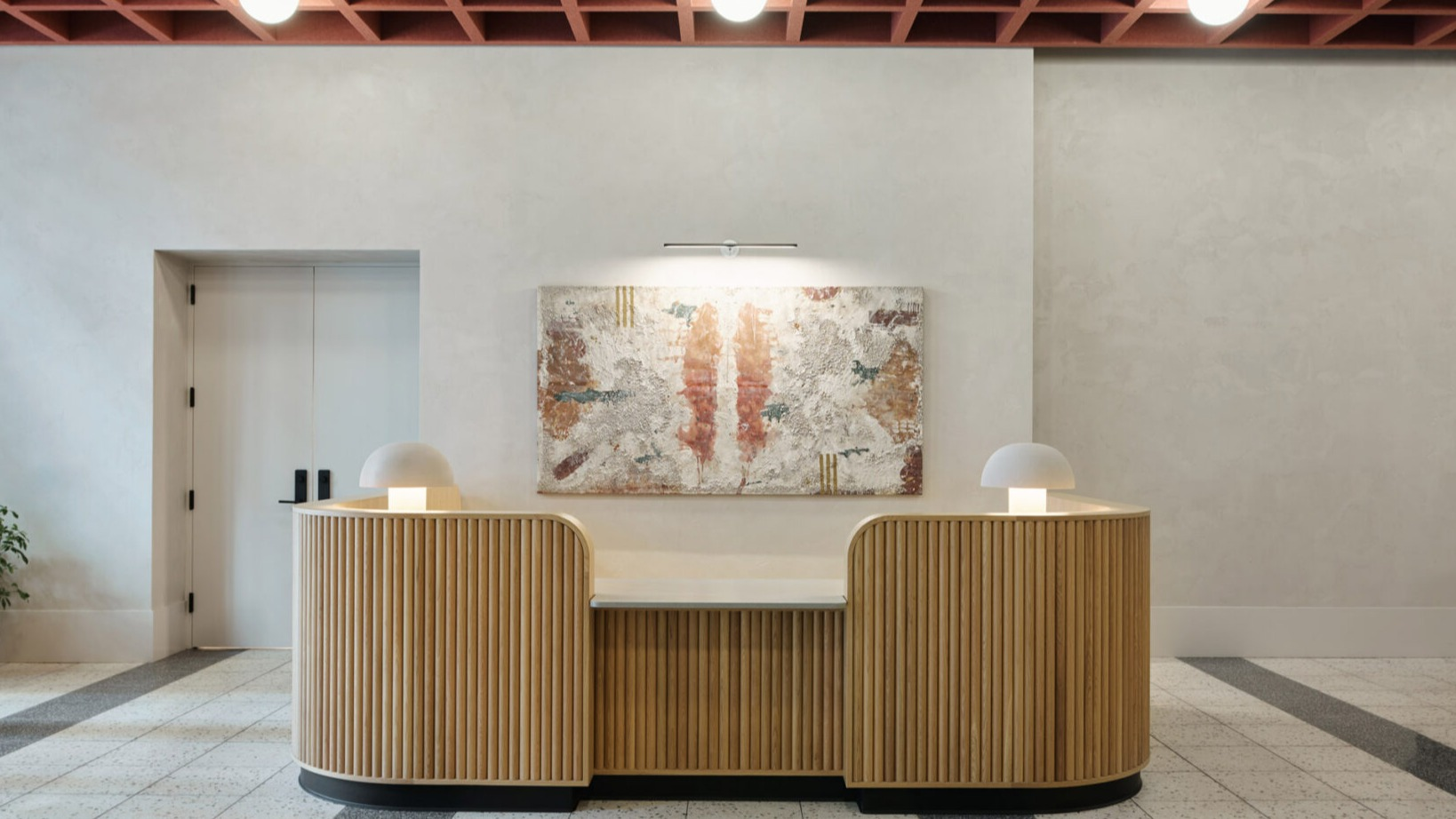Elegant lobby reception desk at Arthur on Aberdeen in Chicago, featuring unique lighting and modern architectural details