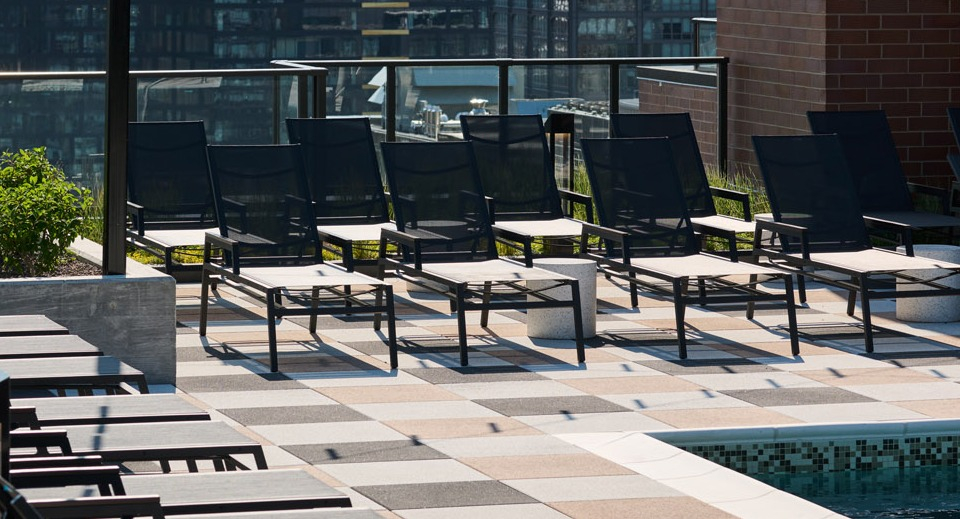 Arthur on Aberdeen rooftop pool area with lounge chairs and stunning city views of Chicago, perfect for relaxation