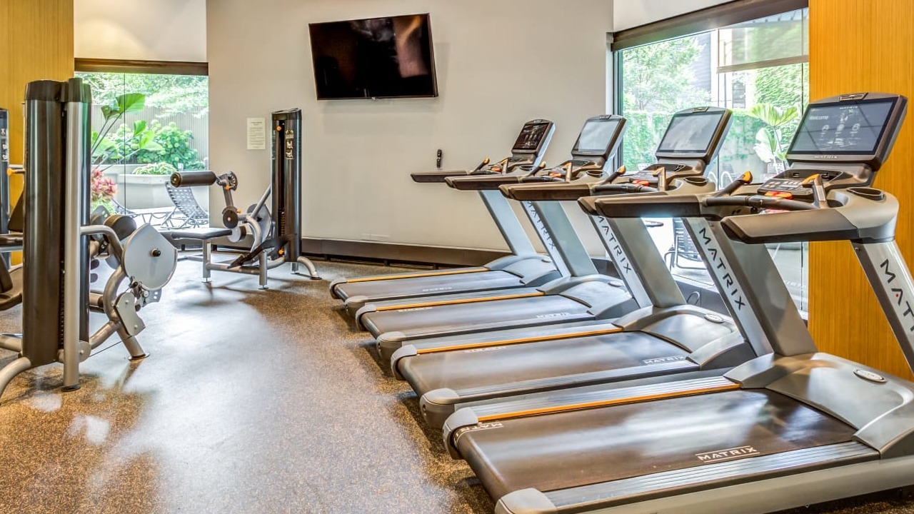 Fitness center at Asbury Plaza in Chicago featuring treadmills and various cardio machines