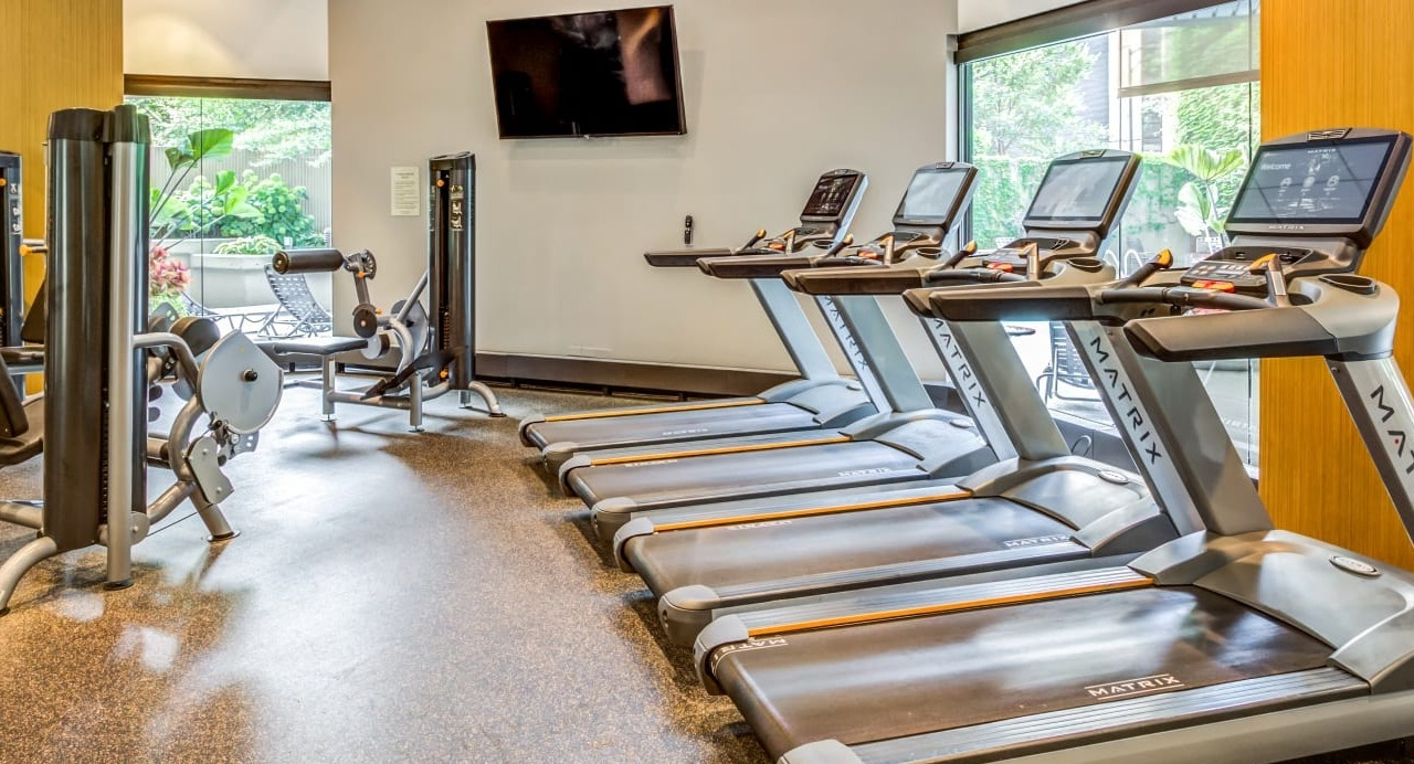 Fitness center at Asbury Plaza in Chicago featuring treadmills and various cardio machines