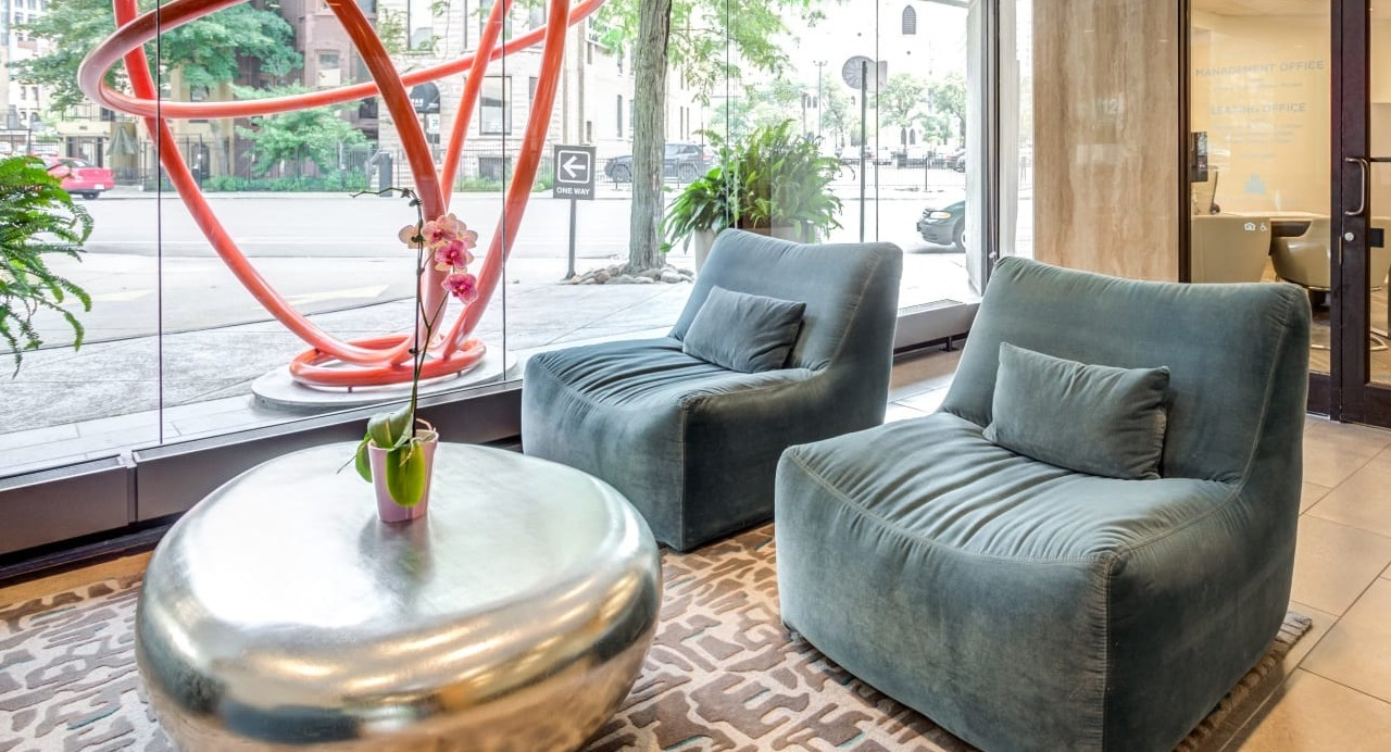 Welcoming resident lounge at Asbury Plaza in Chicago, featuring comfortable seating and large windows