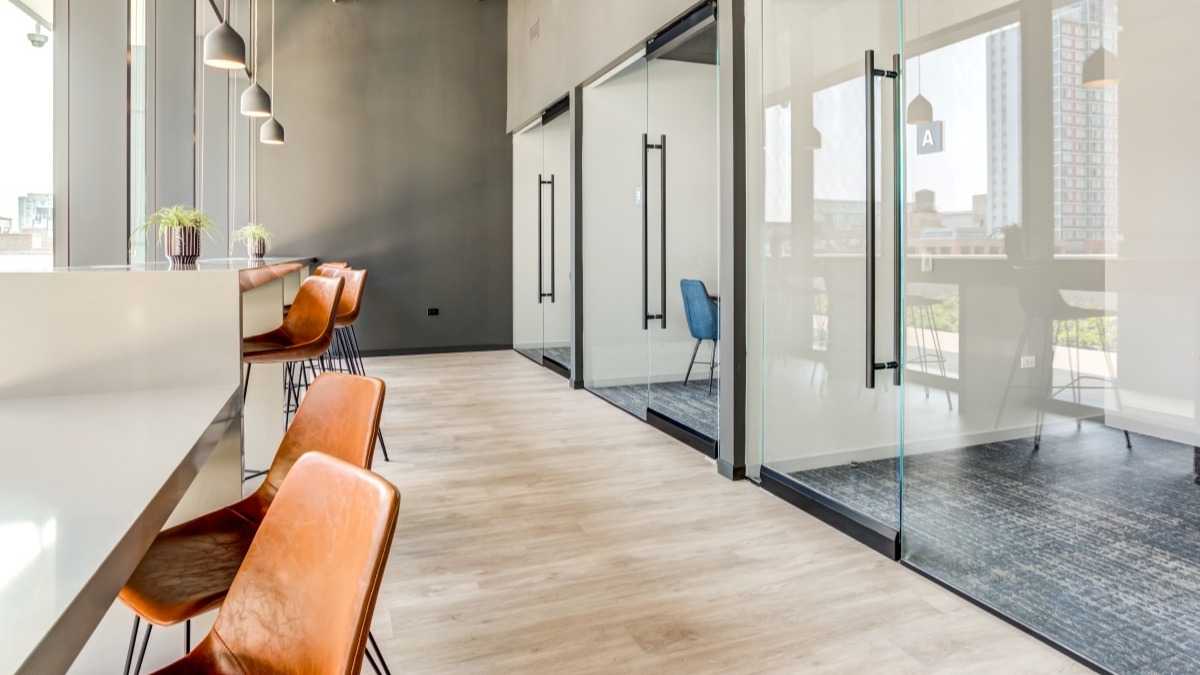 Contemporary co-working space at Aspire Residences in Chicago with private offices and open workstations
