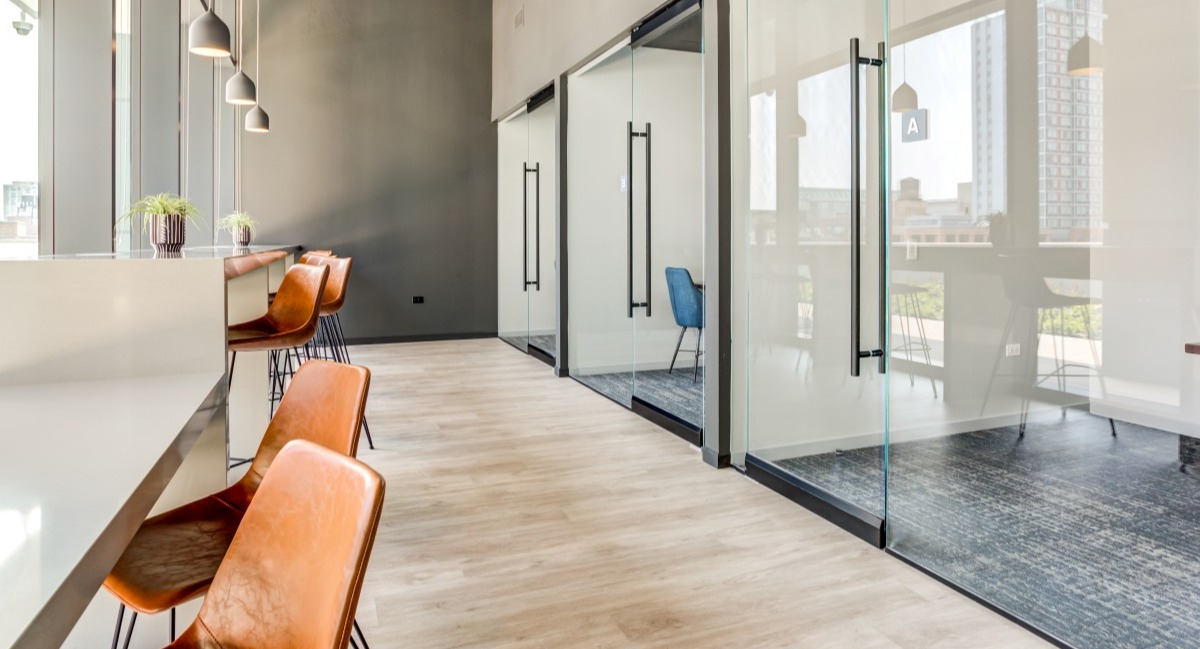 Contemporary co-working space at Aspire Residences in Chicago with private offices and open workstations