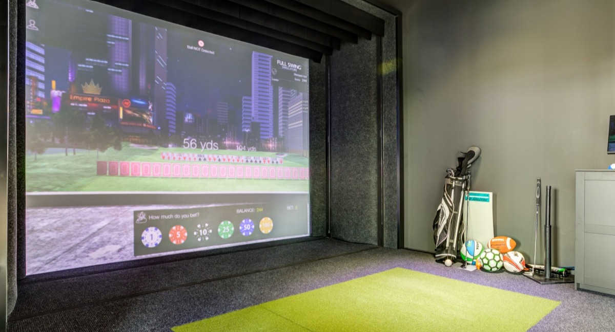 Indoor golf simulator at Aspire Residences in Chicago, perfect for practicing your swing year-round