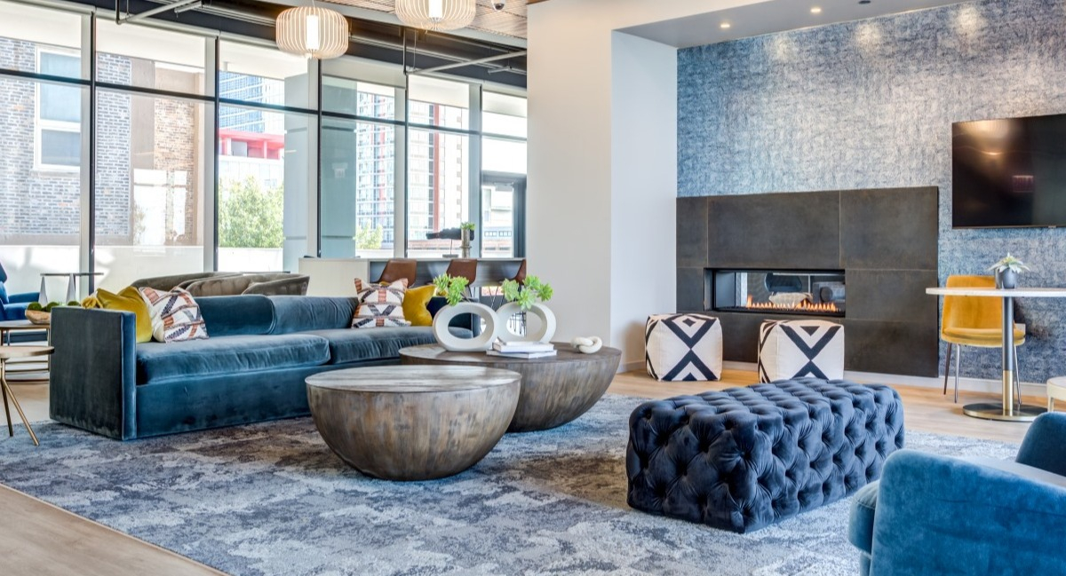 Luxurious resident lounge at Aspire Residences in Chicago with stylish seating, a fireplace, and modern decor