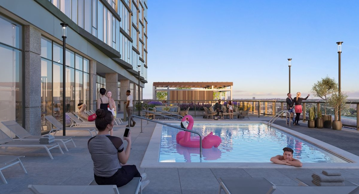 Vibrant rooftop pool deck at Aspire Residences in Chicago, offering lounge chairs and stunning city views