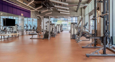 State-of-the-art fitness center with a variety of modern exercise equipment and ample space at Aston Chicago Apartments