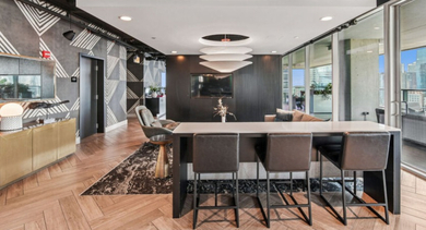 Trendy lounge and bar area with stylish seating, unique wall patterns, and access to an outdoor space at Aston Chicago Apartments