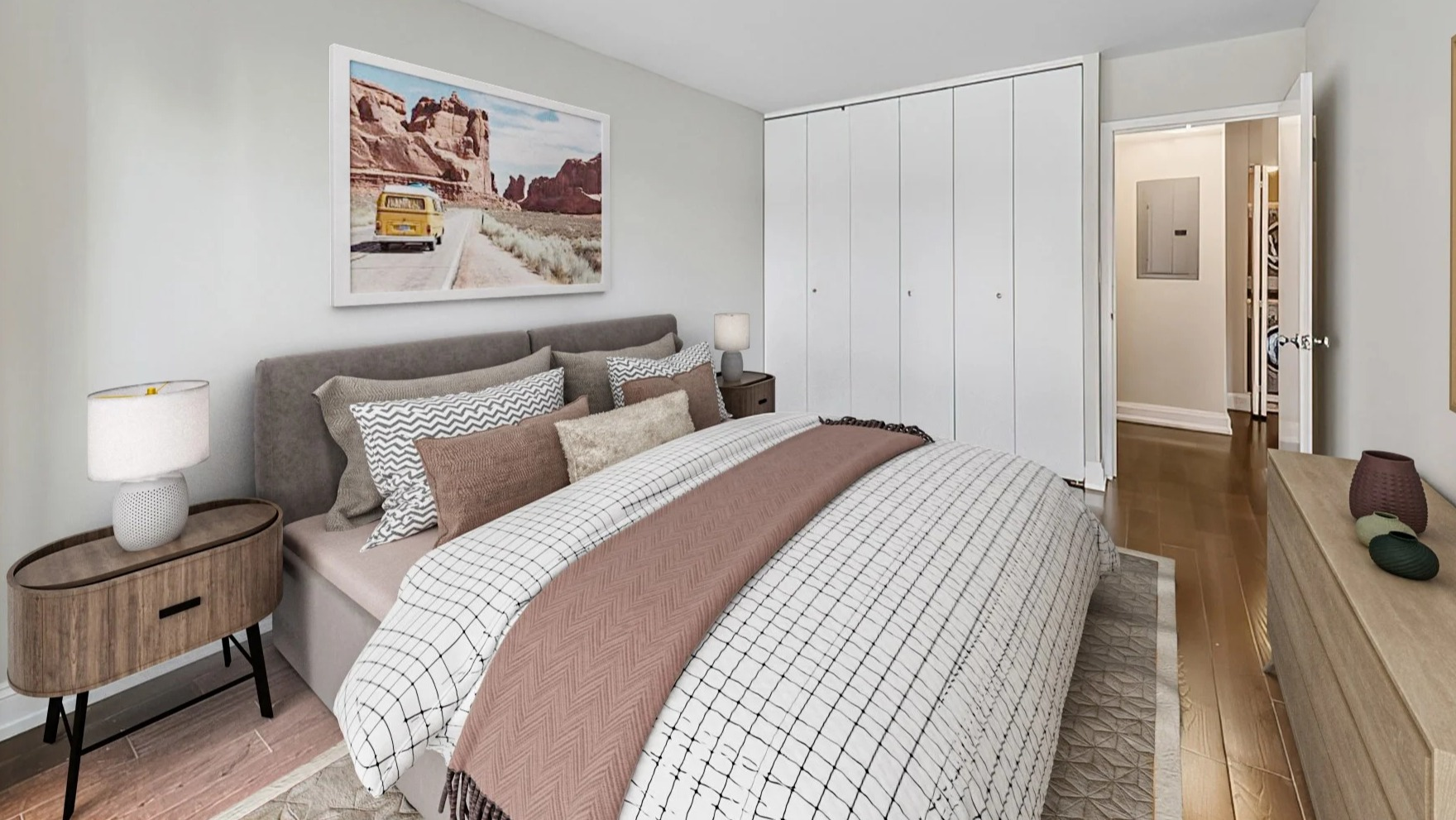 Cozy bedroom featuring a comfortable bed, stylish artwork, and a spacious built-in wardrobe at Astor House Apartments in Chicago