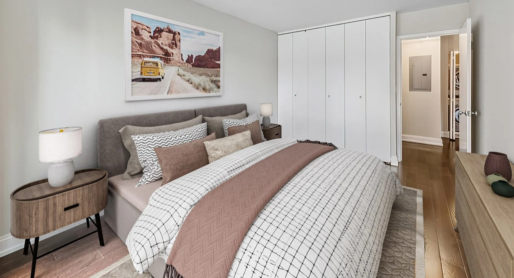 Cozy bedroom featuring a comfortable bed, stylish artwork, and a spacious built-in wardrobe at Astor House Apartments in Chicago