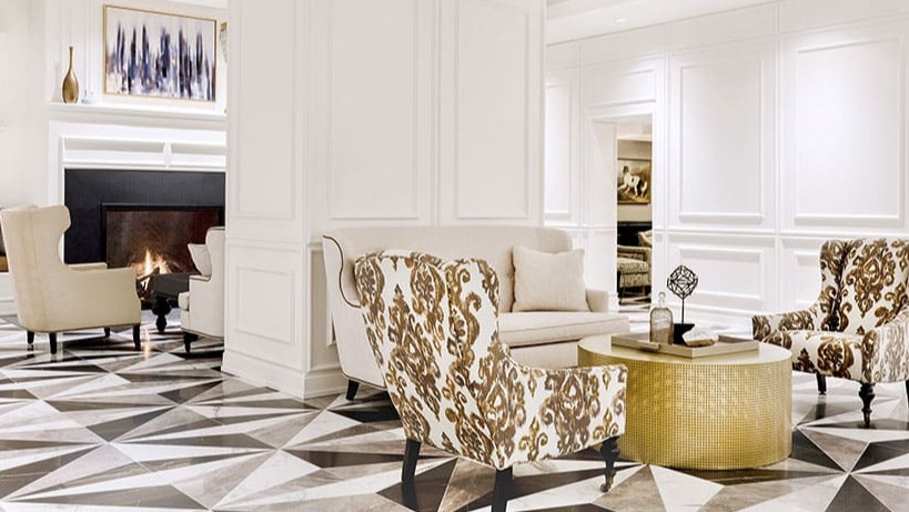 Stylish lobby with a modern fireplace, chic seating, and striking geometric floor patterns at Astor House Apartments in Chicago