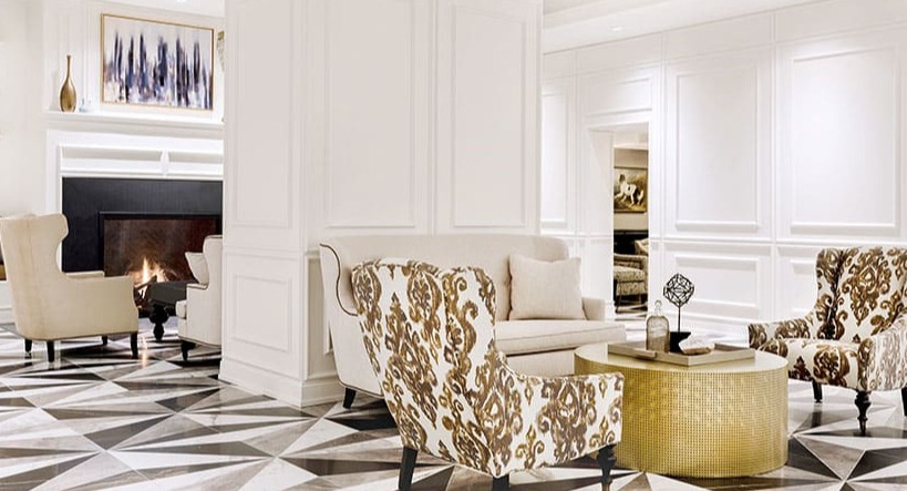 Stylish lobby with a modern fireplace, chic seating, and striking geometric floor patterns at Astor House Apartments in Chicago