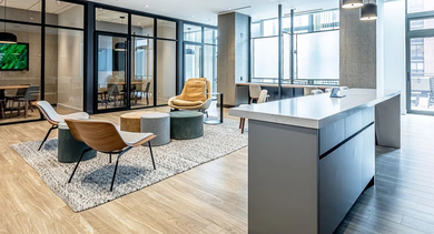Modern lounge and workspace with various seating areas, glass partitions, and a long communal table at Astoria Tower Chicago