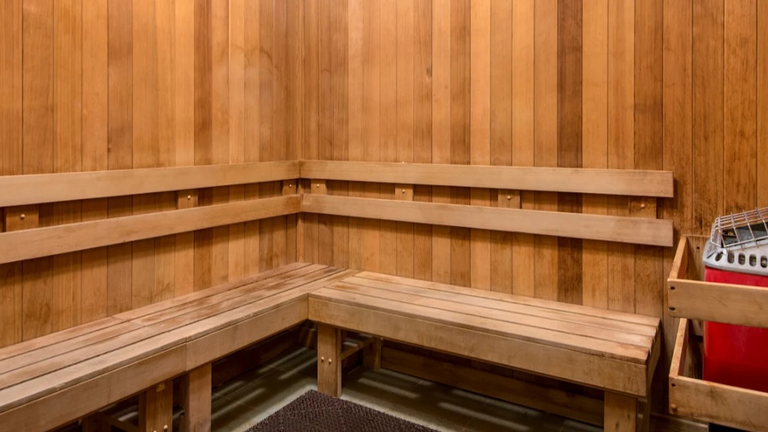 Serene sauna room at Atwater Apartments in Chicago, featuring natural wood paneling, benches, and a relaxing atmosphere