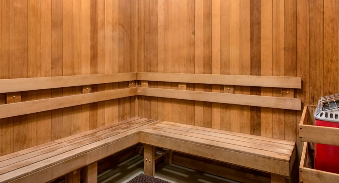 Serene sauna room at Atwater Apartments in Chicago, featuring natural wood paneling, benches, and a relaxing atmosphere