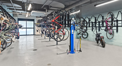 Secure and organized bike storage room with a repair station, perfect for urban cyclists at Avenir apartments in Chicago
