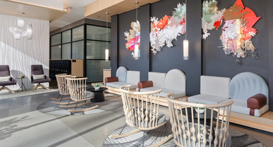 Grand apartment lobby with unique artistic wall installations, stylish seating, and modern decor at Avenir apartments in Chicago