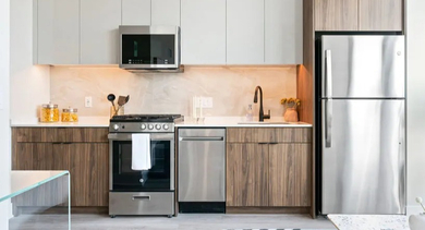 Fully equipped modern apartment kitchen at Avra West Loop in Chicago, featuring stainless steel appliances