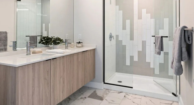 Elegant bathroom with a spacious walk-in shower and modern double vanity at Avra West Loop in Chicago