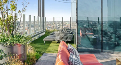 Luxurious rooftop lounge at Avra West Loop in Chicago, offering panoramic city views and comfortable seating