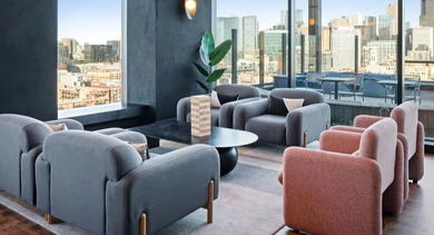Inviting lounge area at Avra West Loop in Chicago with comfortable seating and stunning city views