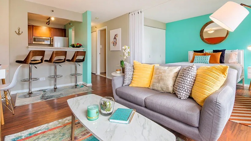 A vibrant studio apartment at Axis Apartments & Lofts in Chicago, featuring a colorful living area and kitchen