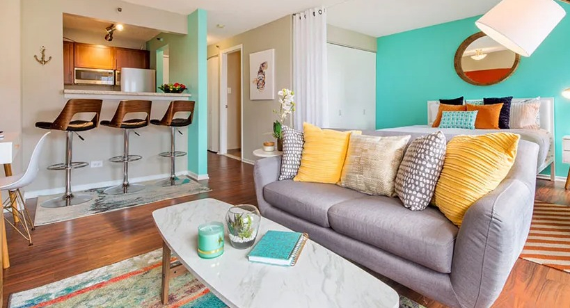 A vibrant studio apartment at Axis Apartments & Lofts in Chicago, featuring a colorful living area and kitchen