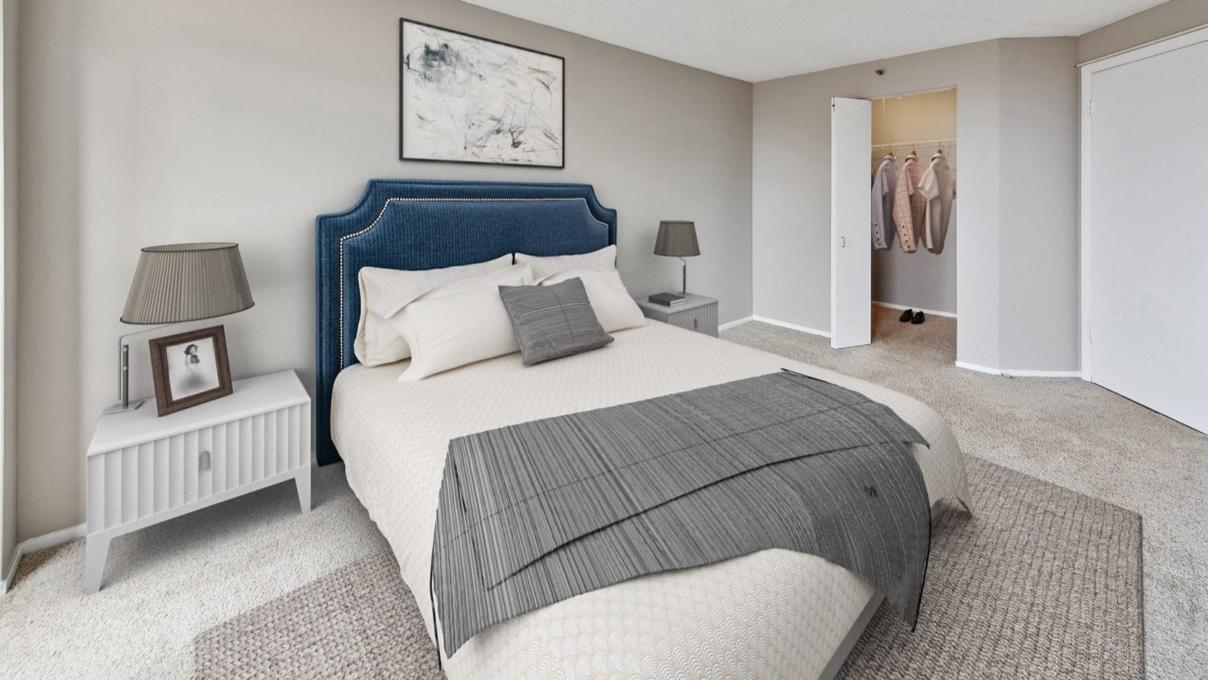 A cozy bedroom with carpeted floors and a walk-in closet at Axis Apartments & Lofts in Chicago