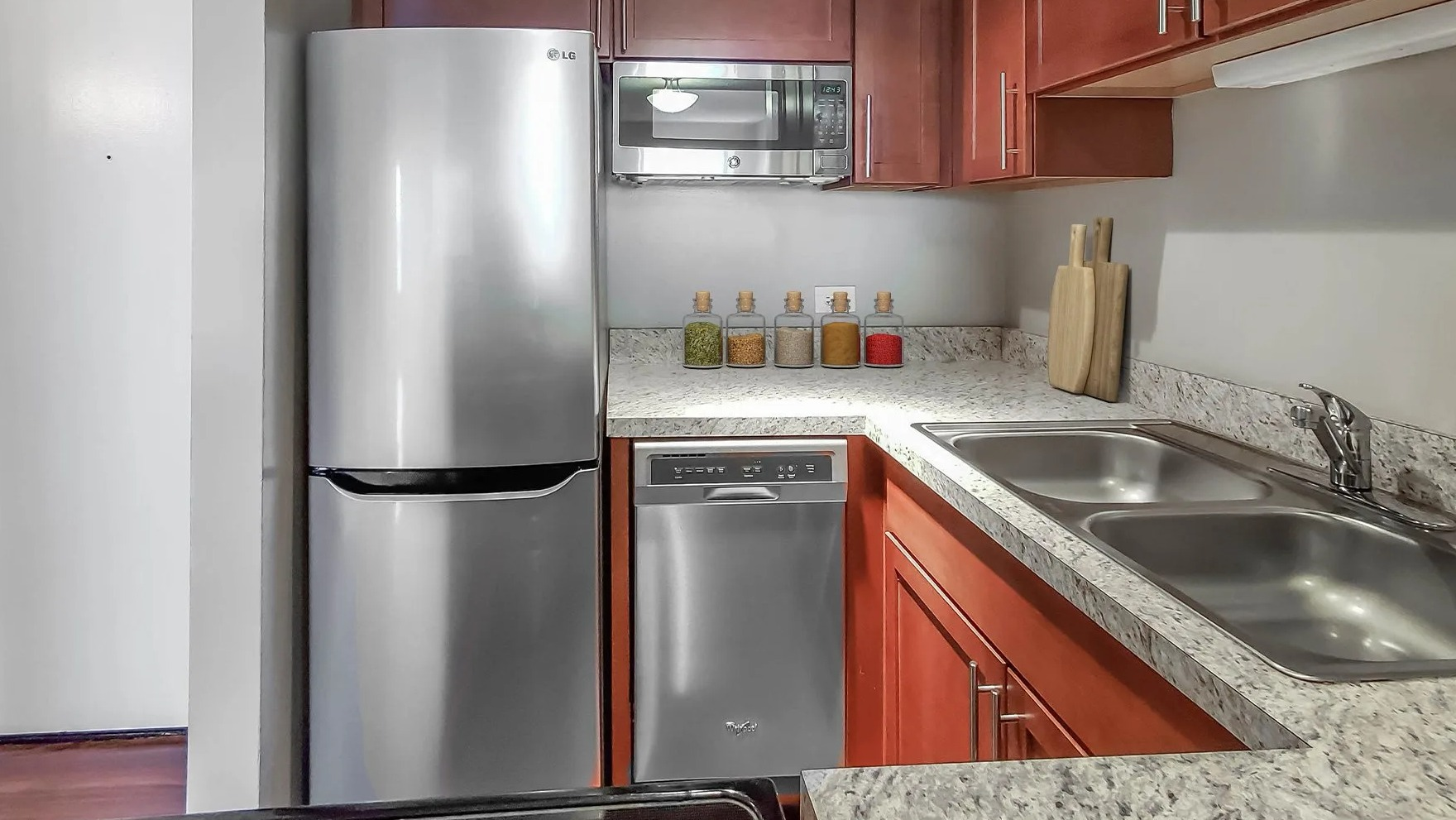 Modern kitchen with stainless steel appliances and ample cabinet space at Axis Apartments & Lofts in Chicago