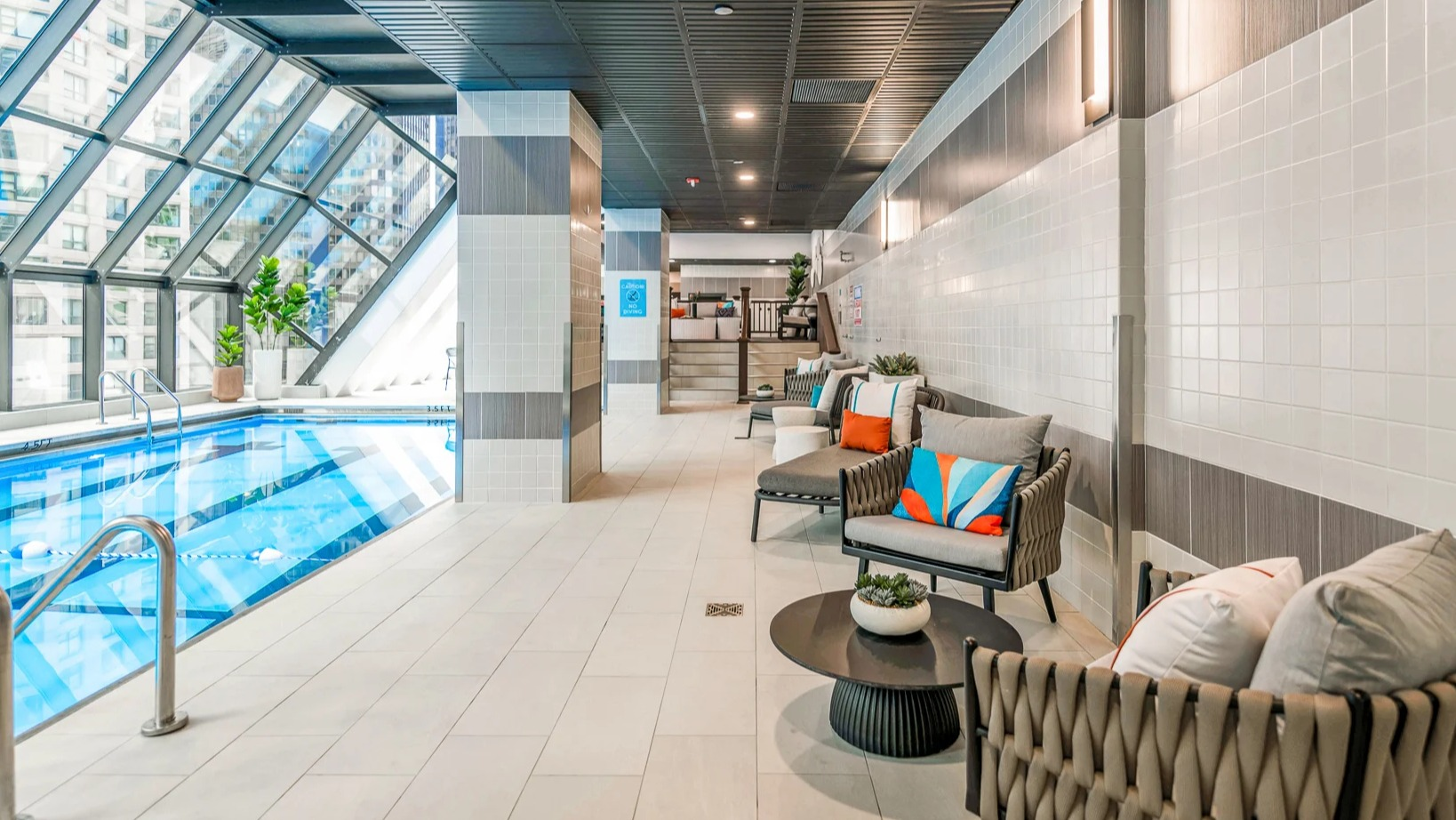 Relaxing poolside lounge area with comfortable seating and city views at Axis Apartments & Lofts in Chicago