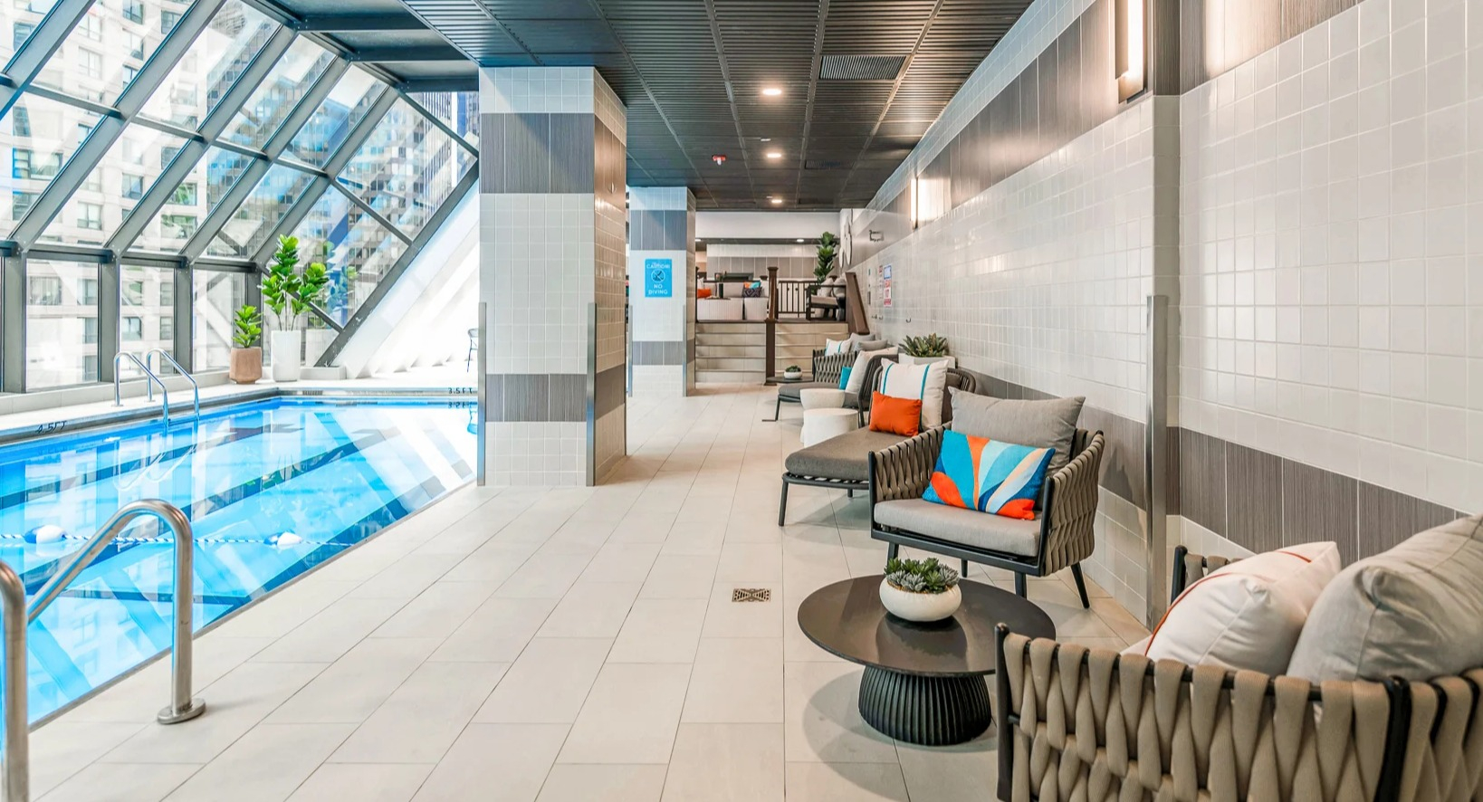 Relaxing poolside lounge area with comfortable seating and city views at Axis Apartments & Lofts in Chicago