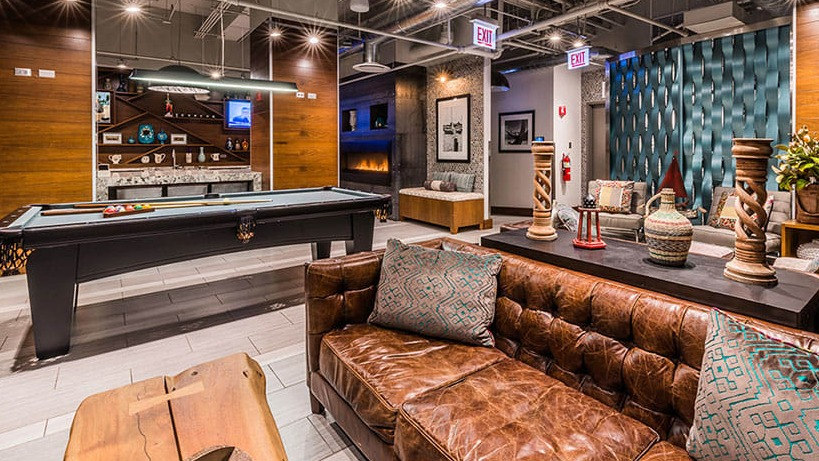 Vibrant resident lounge with billiards and comfortable seating at Axis Apartments & Lofts in Chicago