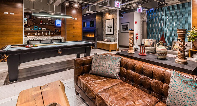 Vibrant resident lounge with billiards and comfortable seating at Axis Apartments & Lofts in Chicago