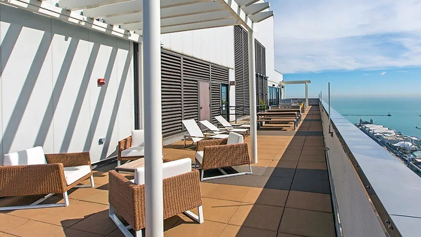 Expansive rooftop terrace at Axis Apartments & Lofts in Chicago, featuring comfortable seating and stunning lake views