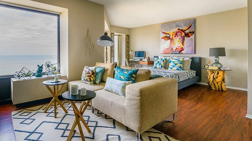 A vibrant studio apartment at Axis Apartments & Lofts in Chicago, featuring a living area and lake views