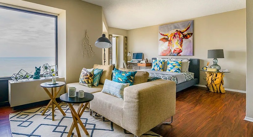 A vibrant studio apartment at Axis Apartments & Lofts in Chicago, featuring a living area and lake views