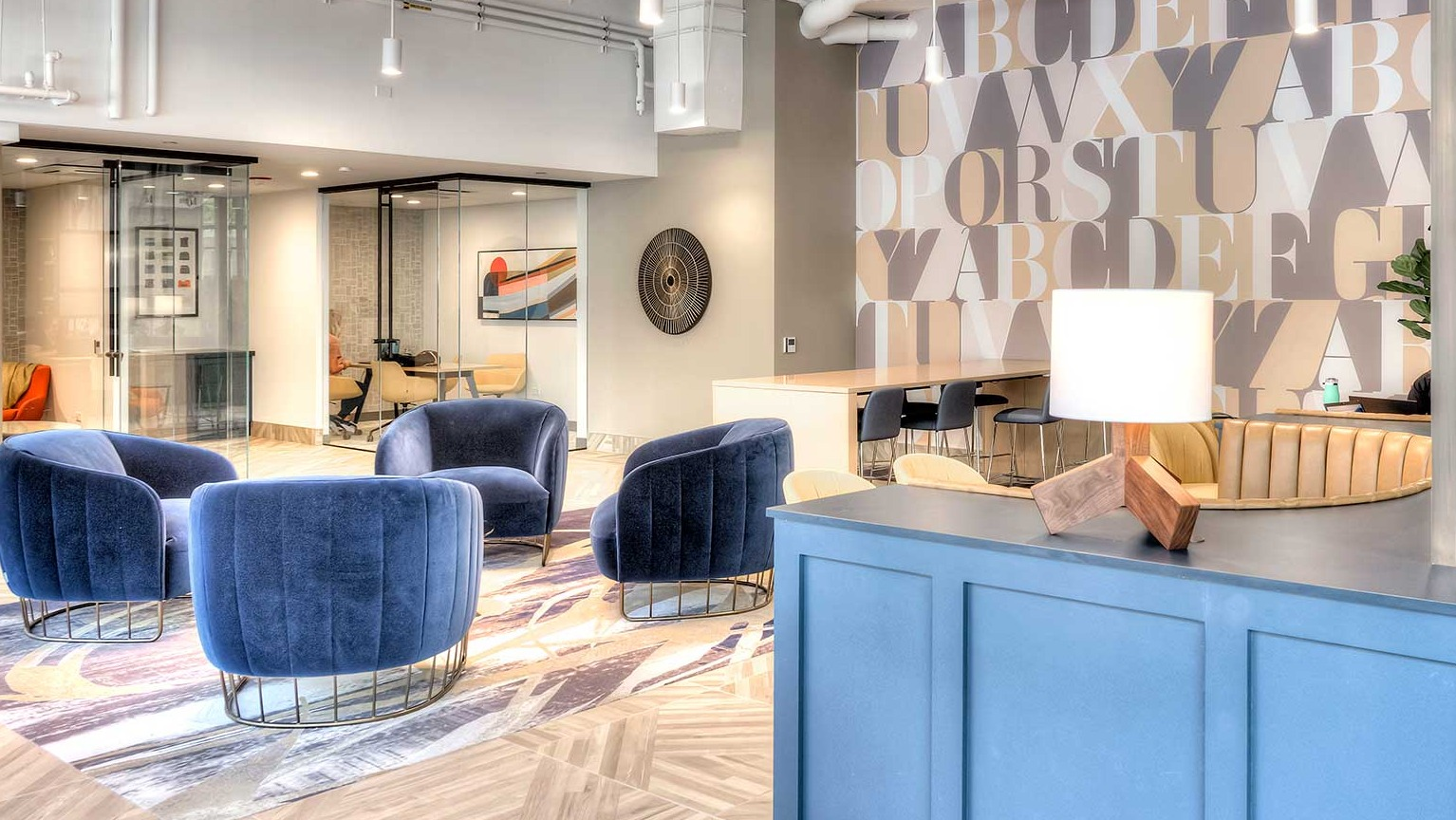 Modern coworking space and lobby area with diverse seating arrangements and large windows, at Burnham Pointe apartments in Chicago