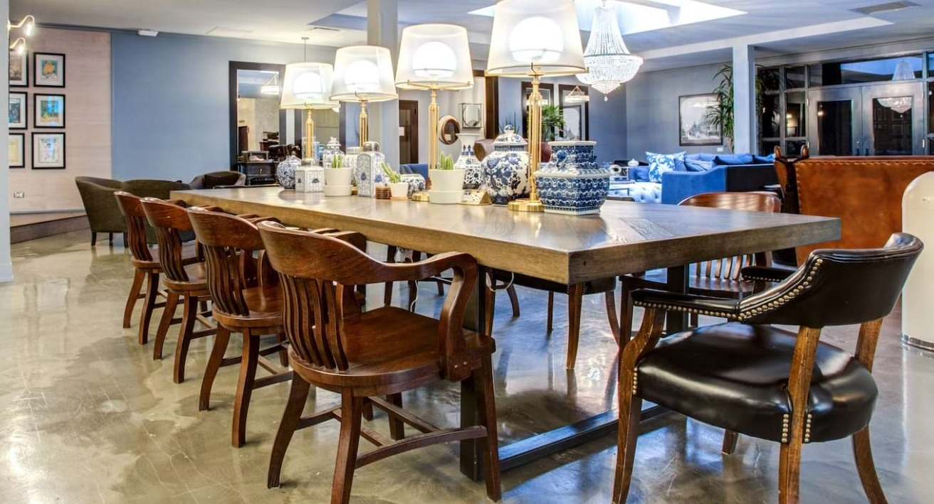 Elegant resident lounge at The Bush Temple in Chicago, featuring a large communal dining table and luxurious seating areas