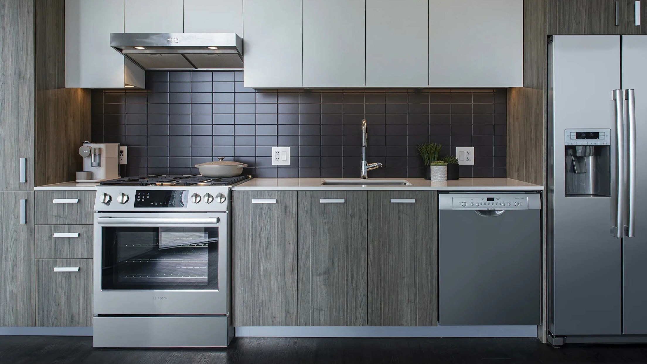 Detailed view of a modern apartment kitchen with stainless steel appliances and ample cabinet space at Cascade Lakeshore East in Chicago