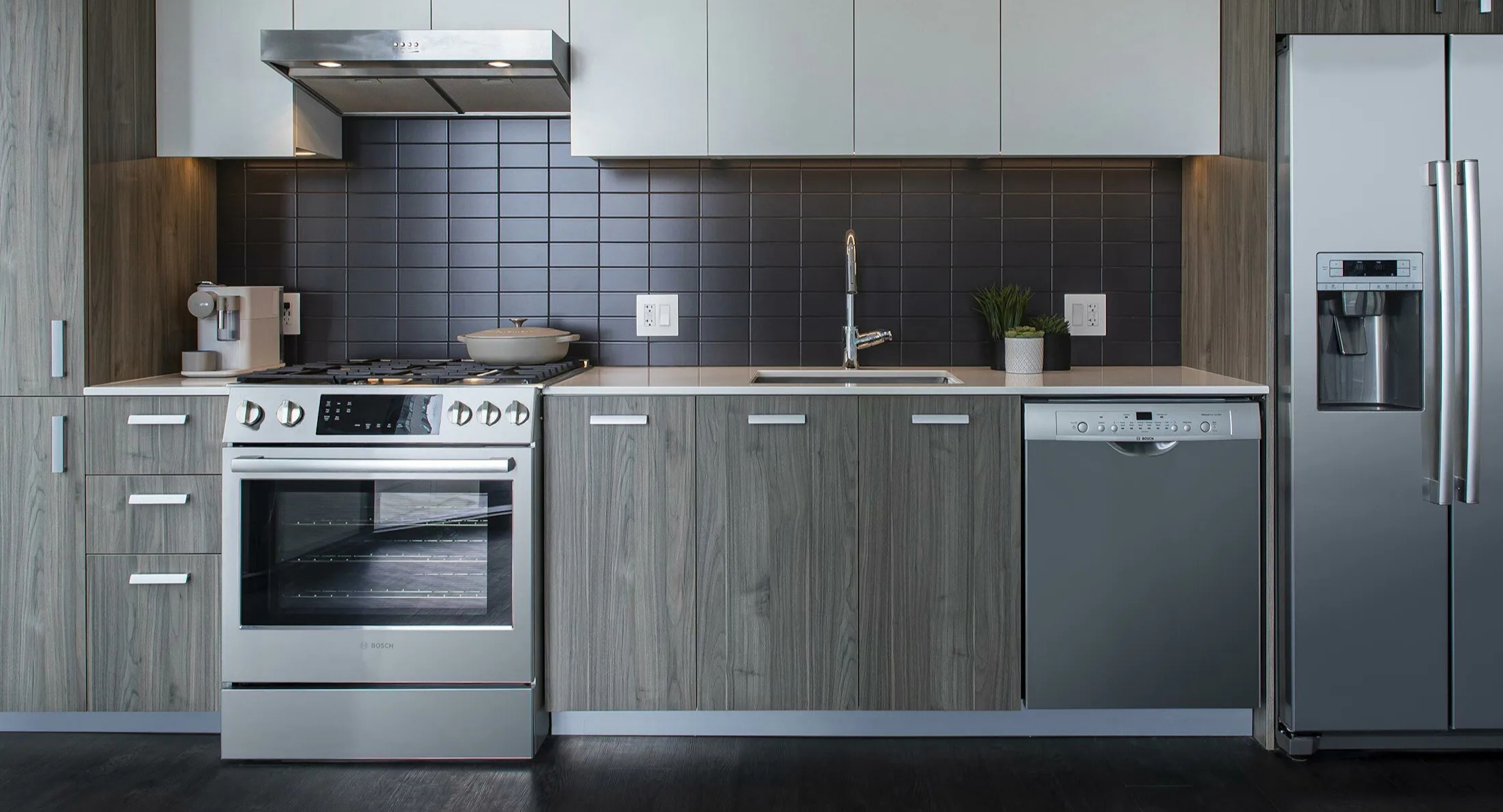 Detailed view of a modern apartment kitchen with stainless steel appliances and ample cabinet space at Cascade Lakeshore East in Chicago