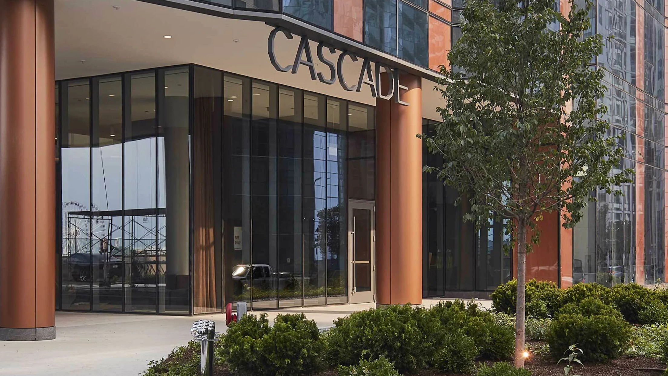 Elegant main entrance of Cascade Lakeshore East, featuring modern architecture and landscaping in Chicago