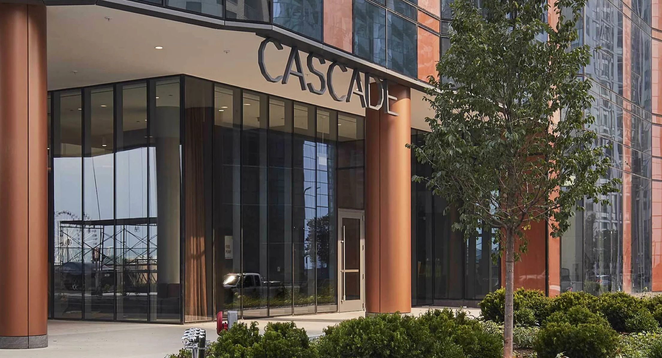 Elegant main entrance of Cascade Lakeshore East, featuring modern architecture and landscaping in Chicago