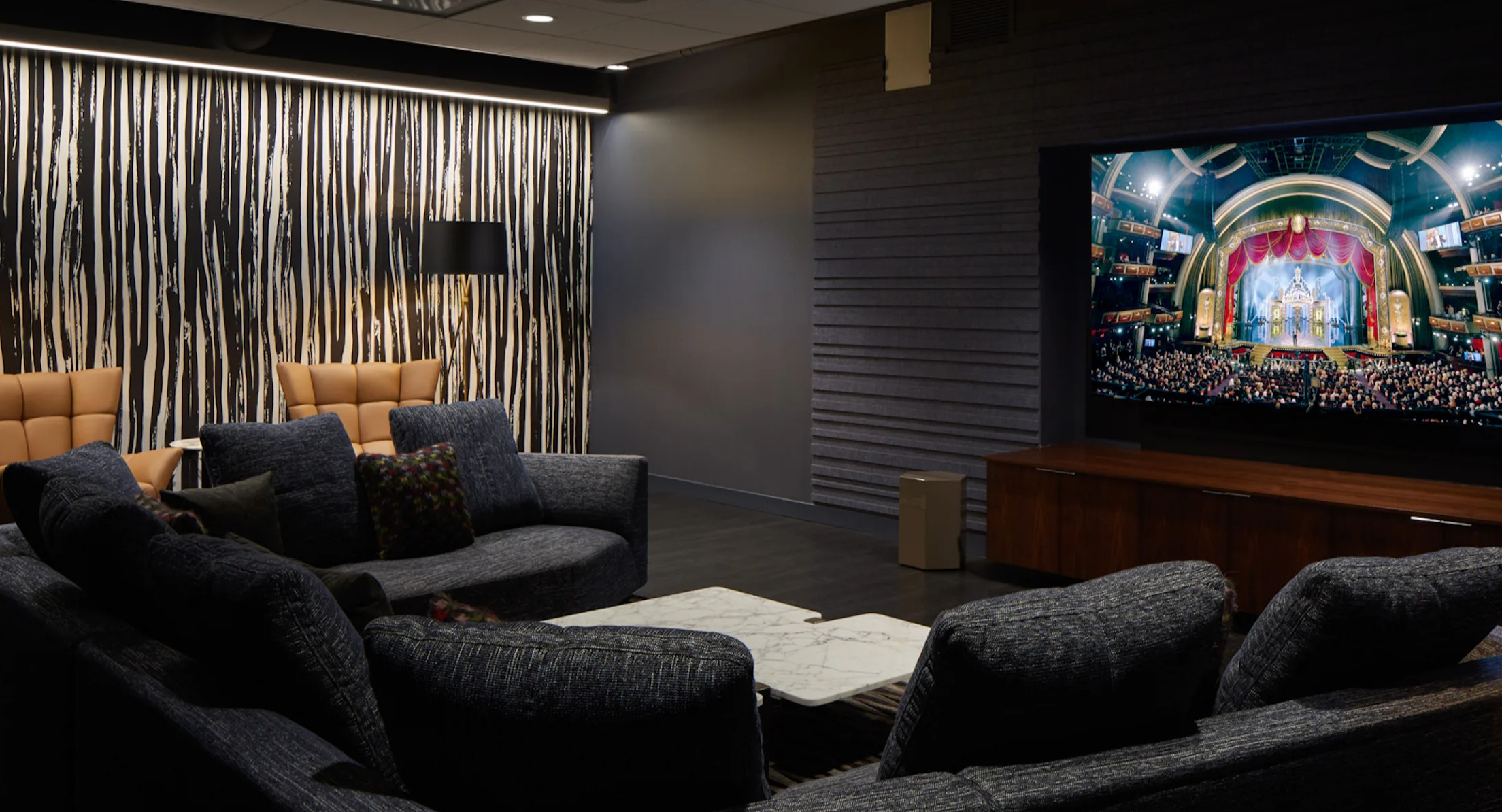 Luxurious media room with comfortable seating and a large screen, ideal for movie nights at Cascade Lakeshore East in Chicago